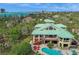 Expansive aerial view of coastal home with pool and ocean backdrop at 26 Sandy Hook S Rd, Sarasota, FL 34242