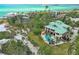 Beautiful coastal home with a private pool, lush greenery, and pristine beachfront access at 26 Sandy Hook S Rd, Sarasota, FL 34242