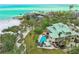 Exclusive coastal property with private beach access, a backyard pool, and lush landscaping at 26 Sandy Hook S Rd, Sarasota, FL 34242