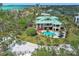 Expansive waterfront property featuring a large home with a private pool and lush tropical landscaping at 26 Sandy Hook S Rd, Sarasota, FL 34242