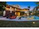 Luxury home with a gorgeous pool, ample seating, a manicured lawn and a backyard designed for entertainment at 26 Sandy Hook S Rd, Sarasota, FL 34242
