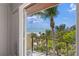 Enjoy breathtaking ocean views from this private balcony surrounded by lush tropical landscaping at 26 Sandy Hook S Rd, Sarasota, FL 34242