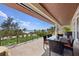 Expansive outdoor balcony with seating, a dining area, and panoramic ocean views at 26 Sandy Hook S Rd, Sarasota, FL 34242