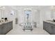 Bright bathroom features a stylish clawfoot tub, dual sinks, and elegant white tile work at 26 Sandy Hook S Rd, Sarasota, FL 34242