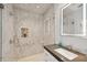 Elegant bathroom with a modern vanity, illuminated mirror, and a luxurious walk-in shower with tiled walls at 26 Sandy Hook S Rd, Sarasota, FL 34242