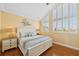 Bright bedroom with large windows, warm yellow walls, and coordinating decor exudes comfort at 26 Sandy Hook S Rd, Sarasota, FL 34242