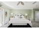 Comfortable bedroom featuring neutral tones, bright windows, and stylish decor for a tranquil retreat at 26 Sandy Hook S Rd, Sarasota, FL 34242