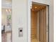 Home elevator with wooden interior and recessed lighting, offering easy access to different floors at 26 Sandy Hook S Rd, Sarasota, FL 34242