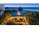 Gorgeous beachfront home with lush landscaping, well-lit entrance, and breathtaking ocean views at 26 Sandy Hook S Rd, Sarasota, FL 34242
