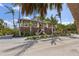 Exterior view of coastal home with elevated design, staircase, and mature landscaping at 26 Sandy Hook S Rd, Sarasota, FL 34242