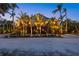 Elegant two-story home with lush tropical landscaping, a grand entrance, and inviting curb appeal at 26 Sandy Hook S Rd, Sarasota, FL 34242