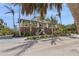Stunning multi-level home surrounded by lush tropical landscaping and a driveway, offering a serene setting at 26 Sandy Hook S Rd, Sarasota, FL 34242