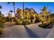 Elegant two-story home with a circular driveway and lush tropical landscaping at 26 Sandy Hook S Rd, Sarasota, FL 34242