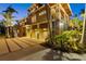 Upscale home featuring a three-car garage, and lush tropical landscaping at 26 Sandy Hook S Rd, Sarasota, FL 34242