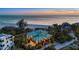 Stunning coastal home with lush landscaping, steps to the beach, and multiple stories at 26 Sandy Hook S Rd, Sarasota, FL 34242