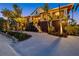 Stunning two-story home with a grand entrance, lush tropical landscaping, and inviting front porch at 26 Sandy Hook S Rd, Sarasota, FL 34242