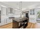 Modern kitchen with a large center island, stainless steel appliances, and marble backsplash at 26 Sandy Hook S Rd, Sarasota, FL 34242