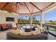 Stylish screened in lanai with comfortable wicker furniture, a television, and stunning ocean views at 26 Sandy Hook S Rd, Sarasota, FL 34242