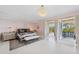 The main bedroom opens to a balcony and is enhanced by the luxury of the chandelier at 26 Sandy Hook S Rd, Sarasota, FL 34242