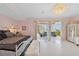 This main bedroom offers access to a private balcony with water views and features a luxurious chandelier at 26 Sandy Hook S Rd, Sarasota, FL 34242