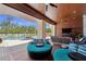 Cozy outdoor patio area with comfortable seating, a TV, and a view of the pool at 26 Sandy Hook S Rd, Sarasota, FL 34242