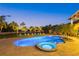 Beautiful backyard pool and hot tub surrounded by lush tropical landscaping and comfortable seating at 26 Sandy Hook S Rd, Sarasota, FL 34242