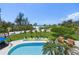 Aerial view of pool, landscaping, and ocean near a coastal home at 26 Sandy Hook S Rd, Sarasota, FL 34242