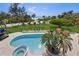 Aerial view of backyard pool with ocean views, lounge chairs, and cabana at 26 Sandy Hook S Rd, Sarasota, FL 34242