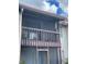 Outdoor balcony with wooden railings on a two-story home offers a place to relax and enjoy the fresh air at 2624 Hidden Lake Dr N # C, Sarasota, FL 34237