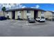 Condominium building with well-maintained landscaping and parking spaces for residents and visitors at 2624 Hidden Lake Dr N # C, Sarasota, FL 34237