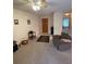 Inviting living room featuring neutral carpet, a cozy armchair, and a view of the entrance at 2624 Hidden Lake Dr N # C, Sarasota, FL 34237