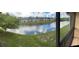 Scenic view from the screened porch of the tranquil canal, showcasing the property's natural surroundings at 2624 Hidden Lake Dr N # C, Sarasota, FL 34237