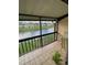 Relaxing screened porch overlooking a serene canal with views of neighboring properties at 2624 Hidden Lake Dr N # C, Sarasota, FL 34237