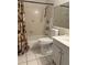 Bathroom with shower-tub combo, seashell-themed shower curtain, and a vanity with sink at 2733 Hidden Lake Blvd # A, Sarasota, FL 34237