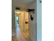 Hallway with view of kitchen with matching tile and access to a bathroom at 2733 Hidden Lake Blvd # A, Sarasota, FL 34237