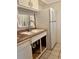 Standard kitchen with white cabinetry, double sink, tile floors and modern appliances at 2733 Hidden Lake Blvd # A, Sarasota, FL 34237