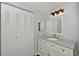 Bathroom with a granite vanity, closet, ample storage, and modern lighting fixtures adding to its charm at 2901 26Th W St # 312, Bradenton, FL 34205