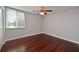 Cozy bedroom featuring a ceiling fan, hardwood floors, a window, and neutral paint tones for a relaxing ambiance at 2901 26Th W St # 312, Bradenton, FL 34205