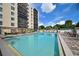Beautiful pool with lounge seating, dining areas, and manicured landscaping at this condominium building at 2901 26Th W St # 312, Bradenton, FL 34205