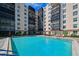 A pristine condo pool area, offering a relaxing and luxurious experience with lounge chairs and lush plants at 2901 26Th W St # 312, Bradenton, FL 34205