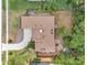 Aerial view of a well-maintained home with mature trees and greenery, including a driveway and backyard at 3006 Wister Cir, Valrico, FL 33596