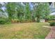 Expansive backyard with mature trees, grass, and a storage shed at 3006 Wister Cir, Valrico, FL 33596