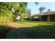 Beautiful backyard features mature trees, and lush green grass at 3006 Wister Cir, Valrico, FL 33596