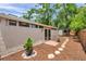 Backyard exterior featuring a sliding door, mulched area, pavers and partial fence at 3006 Wister Cir, Valrico, FL 33596