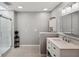 Bright bathroom with a tiled shower, white vanity, decorative floors and neutral walls at 3006 Wister Cir, Valrico, FL 33596