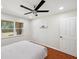 Bright bedroom features cherry-wood floors, modern ceiling fan, and a bright window at 3006 Wister Cir, Valrico, FL 33596