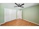 Simple bedroom with green walls, wood floors, and a closet to maximize space at 3006 Wister Cir, Valrico, FL 33596