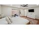 Bedroom with wood floors, ceiling fan, and a view to a private outdoor exercise space at 3006 Wister Cir, Valrico, FL 33596