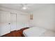 Comfortable bedroom with hardwood floors, a ceiling fan, and double door closets at 3006 Wister Cir, Valrico, FL 33596