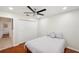 Bedroom features cherry-wood floors, modern ceiling fan, a closet and ensuite bath at 3006 Wister Cir, Valrico, FL 33596